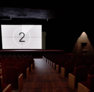 Coded Black gameplay screenshot showing a dark movie theatre with the film about to start.