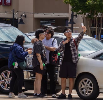 Four North Texas students play around and hang out in the 85C Bakery Cafe parking lot. Photo by Taylor Pleasant