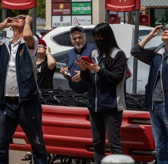 Workers at 99 Ranch Market stand outside the store to watch the solar eclipse. Photo by Taylor Pleasant