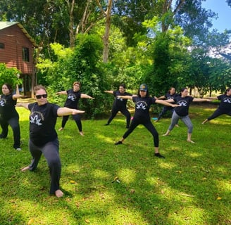 a group of people doing yoga poses in a field