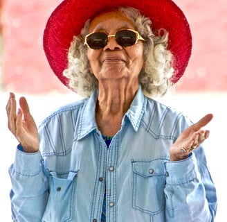 a woman in a red hat and sunglasses