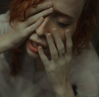 a woman with red hair and a white shirt