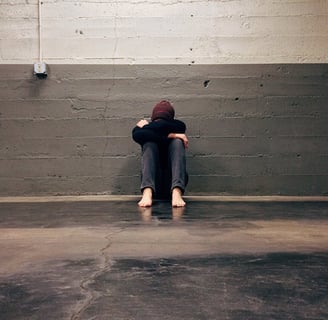 a person sitting on the floor in a room