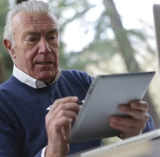 a man in a blue sweater and a laptop