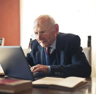 a man in a suit and tie is sitting at a desk