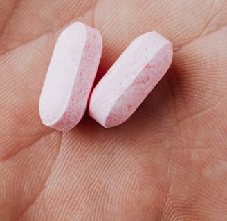 two pills on a person's hand holding a pill pill