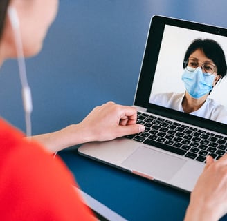 a woman in a red shirt and a mask on her face