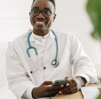 a smiling doctor in a white coat and glasses