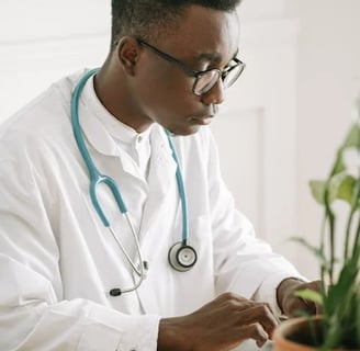 a male doctor in a white lab coat and stethrobe