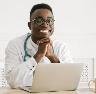 a male doctor in a white coat and glasses