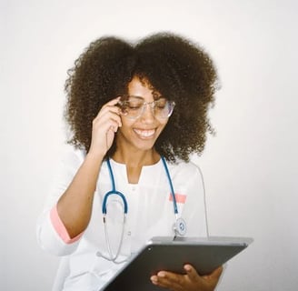 a woman in a white lab coat and glasses talking on a cell phone