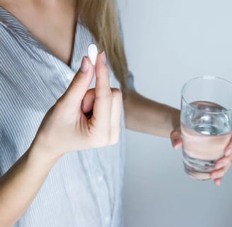 a woman holding a pill pill in her hand