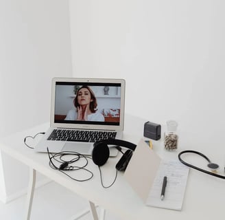 a laptop computer sitting on a table with a doctor's stethrobe