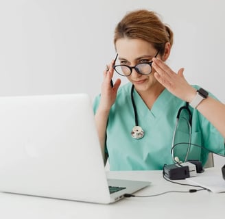 a woman in a green scrub suit and glasses