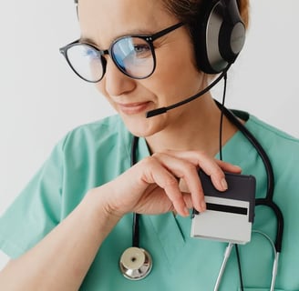 a nurse in a green scrub suit and headphones