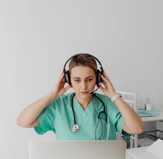 a woman in a green scrub suit and a stethoscope on her head