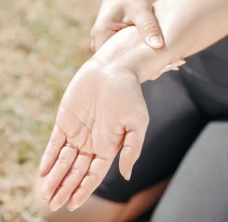 a woman holding her hand out to show off her hand