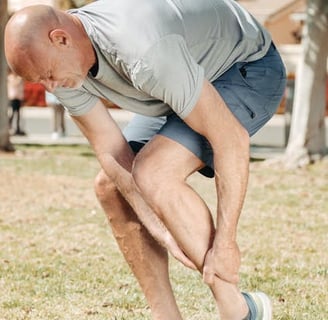 a man in a gray shirt is holding a frisbee