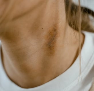 a woman with a white shirt and a brown sweater