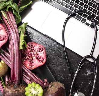 a laptop computer and a stethoscope on a table