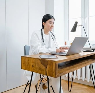 a woman in a white lab coat and a stethoscope on a desk