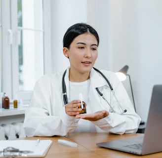 a woman doctor in a white coat and a laptop