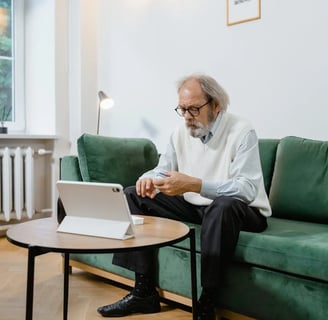 a man sitting on a couch with a laptop