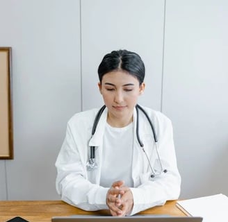 a woman in a white lab coat and a stethrobe