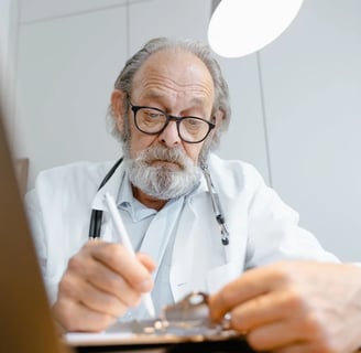 a man in a lab coat and glasses is looking at a clipboard