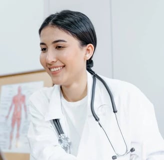 a woman doctor in a white coat and a laptop