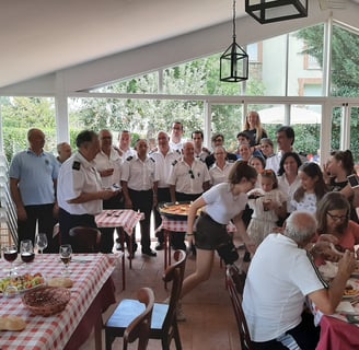 a group of people sitting at a table with food