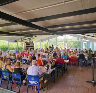 a large group of people sitting at tables in a restaurant