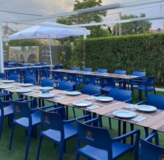 a restaurant with blue chairs and tables and umbrellas