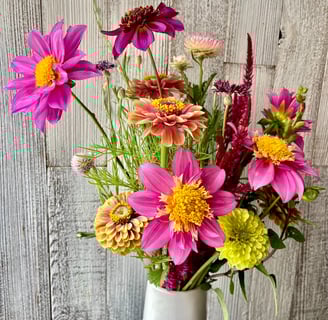 vase of flowers with pink dahlias, zinnias, celosia