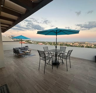 Casa Janet patio occean view with tables and umbrellas