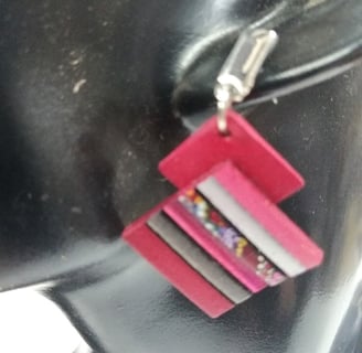 a woman's earring with a pink and white striped necklace