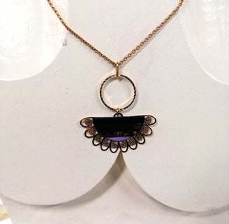 a necklace with a purple and gold necklace