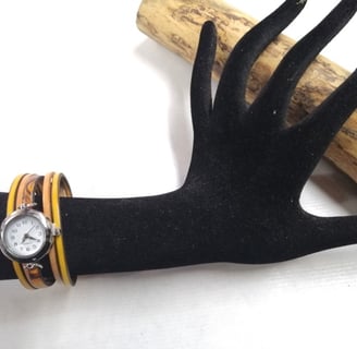 a wrist watch with a wooden bracelet and a watch on it