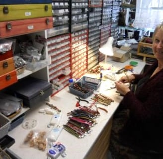 a woman in a red sweater is sitting at a desk