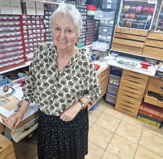 a woman standing in a craft shop