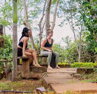 retreat guests sitting around bonfire in sacred garden