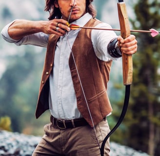 a man in a vest and vest holding a bow