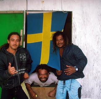 Three local guys with Swedish flag in Raroia, French Polynesia