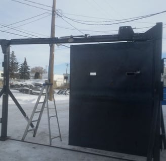 a black metal gate with a ladder and a ladder
