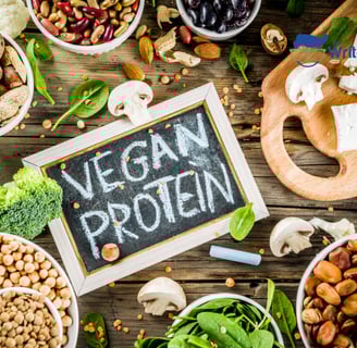 a variety of food items including nuts, mushrooms, broccoli, spinach, and sign in the middle