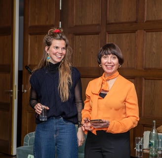 Two confident women, public speaking coaches, at workshop