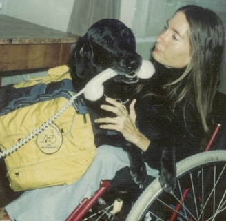 a woman in a wheelchair with a dog