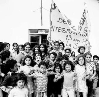 a group of children and adults standing in front of a building