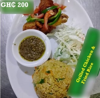 Grilled chicken and fried rice at de place restaurant Ghana