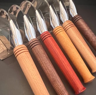 Collection of pizza cutters with various wood handles